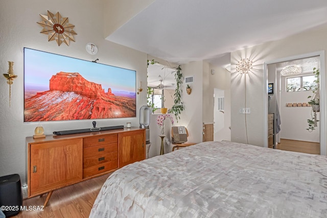 7622 E Callisto Cir Unit 204, Tucson, AZ 85715 - bedroom featuring wood finished floors and multiple windows