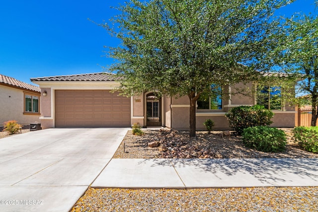 5950 S Hoptree Pl, Tucson, AZ 85747 - view of front of property featuring an attached garage, stucco siding, driveway, and a tiled roof