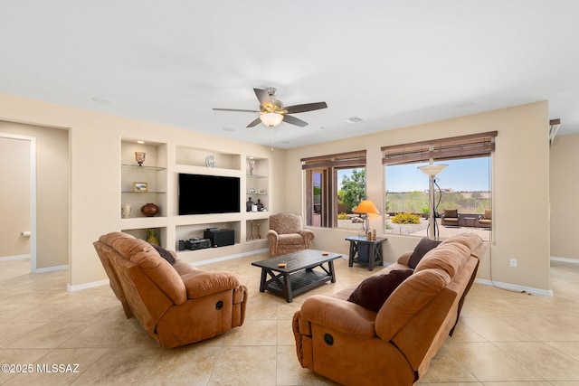 5950 S Hoptree Pl, Tucson, AZ 85747 - living area with light tile patterned floors, a ceiling fan, built in features, and baseboards