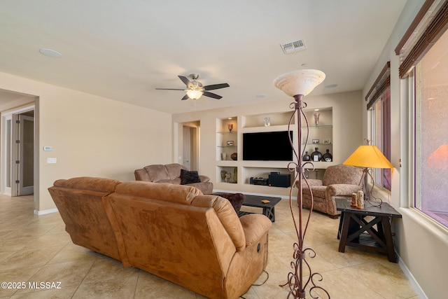 5950 S Hoptree Pl, Tucson, AZ 85747 - living area with light tile patterned floors, ceiling fan, built in features, and baseboards