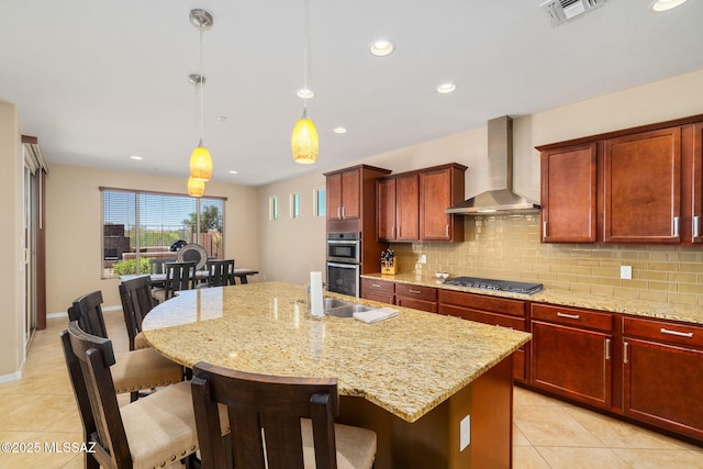 5950 S Hoptree Pl, Tucson, AZ 85747 - kitchen featuring wall chimney range hood, stainless steel appliances, light tile patterned floors, tasteful backsplash, and recessed lighting