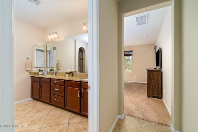 5950 S Hoptree Pl, Tucson, AZ 85747 - bathroom featuring tile patterned flooring, double vanity, and baseboards