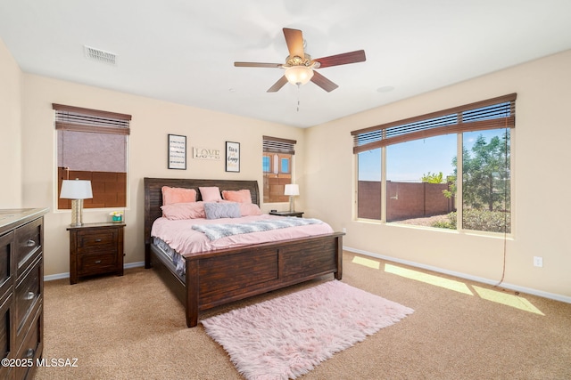 5950 S Hoptree Pl, Tucson, AZ 85747 - bedroom with light colored carpet, baseboards, and a ceiling fan