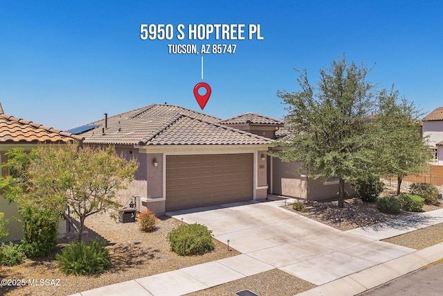 5950 S Hoptree Pl, Tucson, AZ 85747 - view of front facade featuring a garage, a tile roof, and stucco siding
