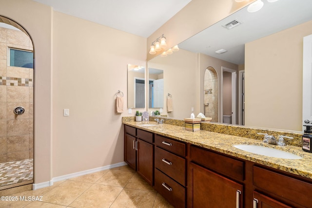 5950 S Hoptree Pl, Tucson, AZ 85747 - full bath with a tile shower, tile patterned flooring, double vanity, toilet, and baseboards
