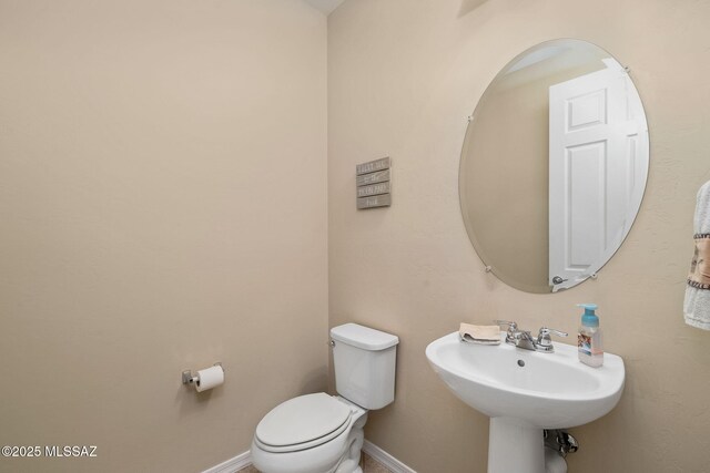5950 S Hoptree Pl, Tucson, AZ 85747 - bathroom with toilet, baseboards, and a sink