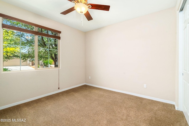 5950 S Hoptree Pl, Tucson, AZ 85747 - spare room featuring carpet flooring, baseboards, and a ceiling fan