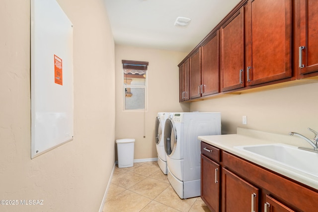 5950 S Hoptree Pl, Tucson, AZ 85747 - laundry area featuring cabinet space, washer and dryer, baseboards, and light tile patterned floors