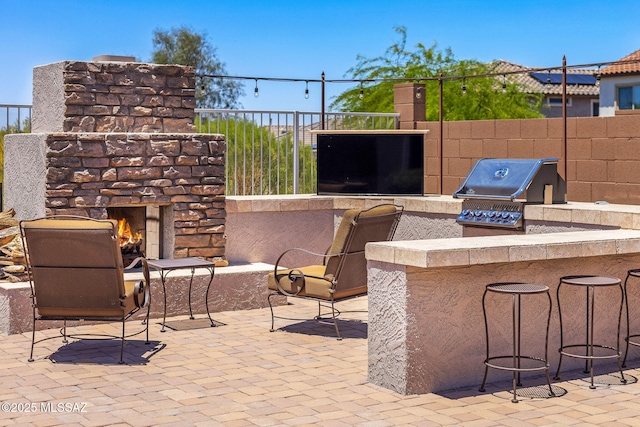 5950 S Hoptree Pl, Tucson, AZ 85747 - view of patio with an outdoor stone fireplace, area for grilling, and fence