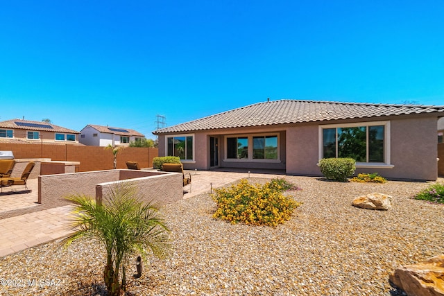 5950 S Hoptree Pl, Tucson, AZ 85747 - rear view of property with a tile roof and stucco siding