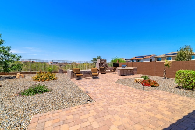 5950 S Hoptree Pl, Tucson, AZ 85747 - view of patio featuring a fenced backyard and exterior kitchen