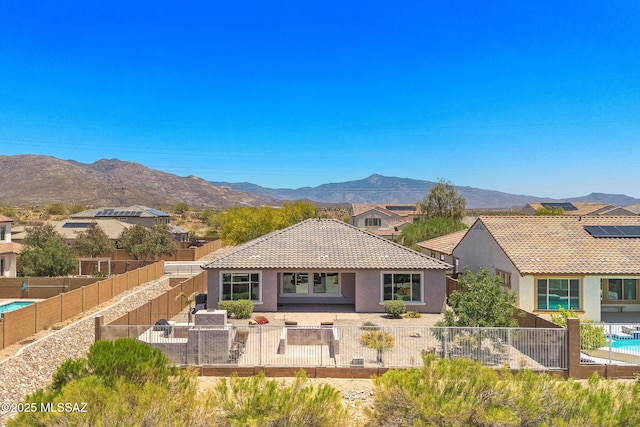 5950 S Hoptree Pl, Tucson, AZ 85747 - back of house featuring stucco siding, a fenced backyard, a mountain view, a tile roof, and a patio area