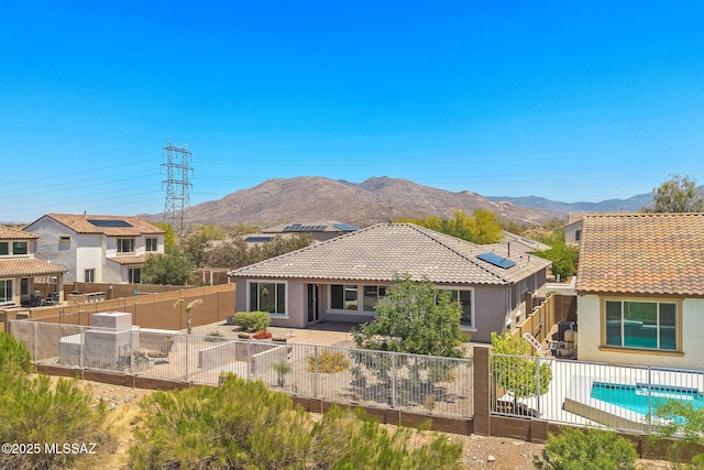 5950 S Hoptree Pl, Tucson, AZ 85747 - rear view of property featuring stucco siding, a tiled roof, and a fenced backyard