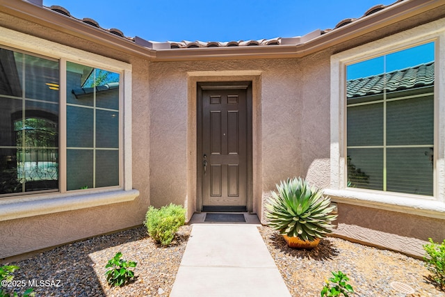 5950 S Hoptree Pl, Tucson, AZ 85747 - doorway to property featuring stucco siding