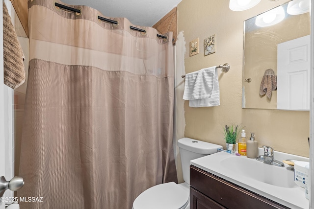 4760 W Tumacacori Dr, Amado, AZ 85645 - bathroom with toilet, vanity, a textured wall, and a shower with curtain
