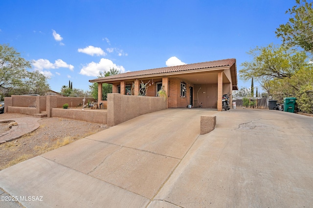 4760 W Tumacacori Dr, Amado, AZ 85645 - view of front of house featuring driveway, a tile roof, fence, and a carport