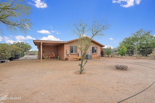 4760 W Tumacacori Dr, Amado, AZ 85645 - back of property featuring central AC, fence, and a gate