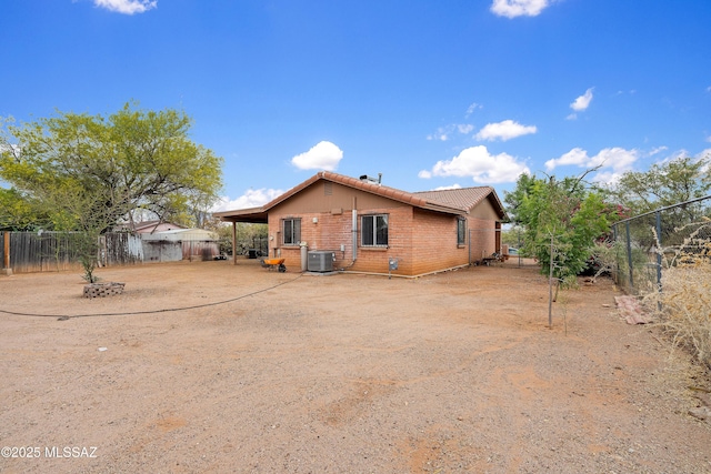 4760 W Tumacacori Dr, Amado, AZ 85645 - rear view of property with central AC unit, a fenced backyard, brick siding, and a tiled roof