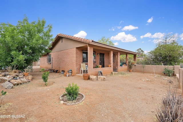4760 W Tumacacori Dr, Amado, AZ 85645 - rear view of property with fence and brick siding