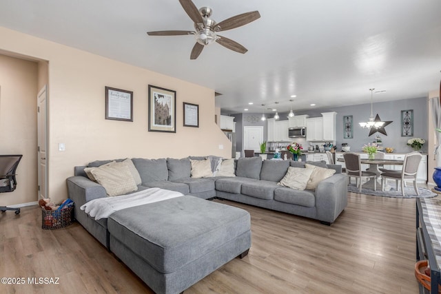 14247 E Axle Dr, Vail, AZ 85641 - living room with ceiling fan, light wood-style floors, a chandelier, and recessed lighting