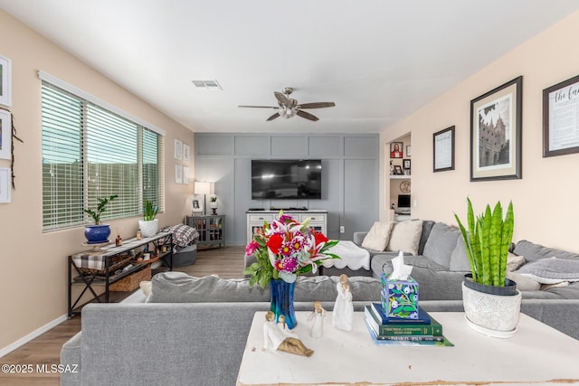 14247 E Axle Dr, Vail, AZ 85641 - living area featuring wood finished floors, a ceiling fan, and baseboards