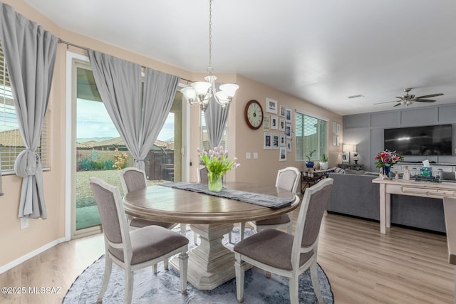 14247 E Axle Dr, Vail, AZ 85641 - dining space featuring light wood-type flooring, a chandelier, and ceiling fan