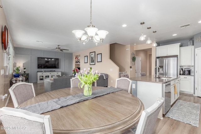 14247 E Axle Dr, Vail, AZ 85641 - dining area featuring light wood-type flooring, ceiling fan, a chandelier, and recessed lighting