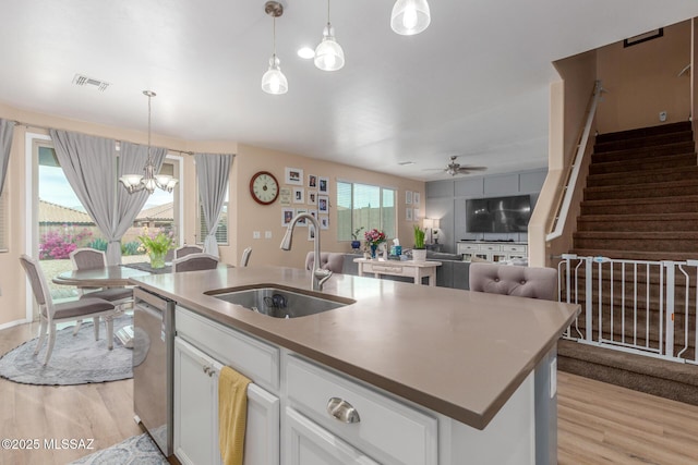 14247 E Axle Dr, Vail, AZ 85641 - kitchen with a sink, light wood-type flooring, a chandelier, dishwasher, and white cabinetry