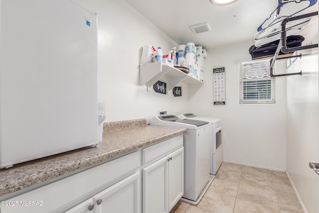 14247 E Axle Dr, Vail, AZ 85641 - laundry room with washing machine and clothes dryer, cabinet space, baseboards, and light tile patterned floors