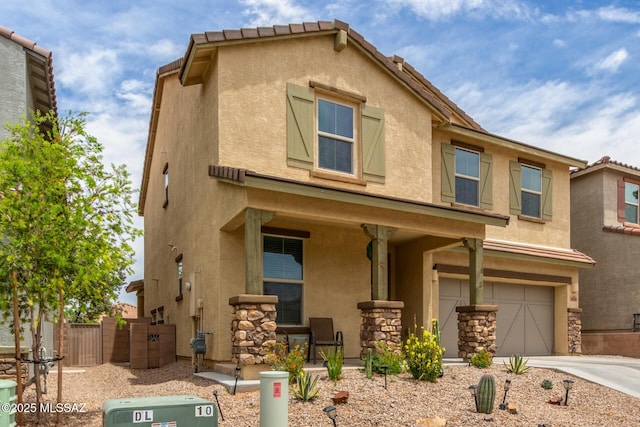 14247 E Axle Dr, Vail, AZ 85641 - view of front of home with stucco siding, a garage, concrete driveway, fence, and covered porch