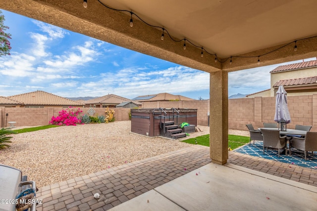 14247 E Axle Dr, Vail, AZ 85641 - view of patio / terrace with a hot tub, a fenced backyard, and outdoor dining space