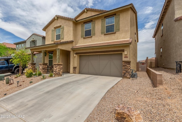 14247 E Axle Dr, Vail, AZ 85641 - view of front facade featuring a garage, stucco siding, fence, and concrete driveway
