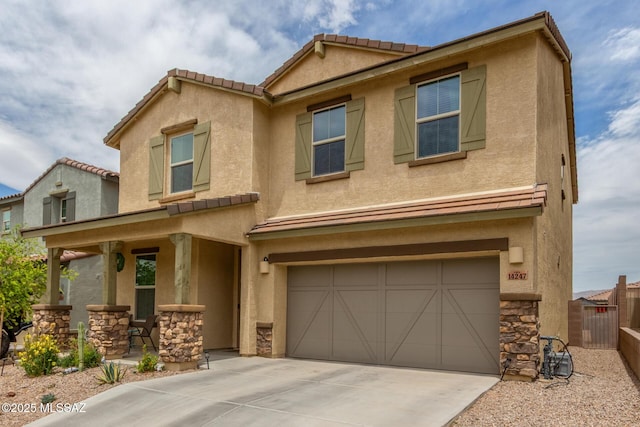 14247 E Axle Dr, Vail, AZ 85641 - townhome / multi-family property featuring a garage, stone siding, concrete driveway, fence, and stucco siding