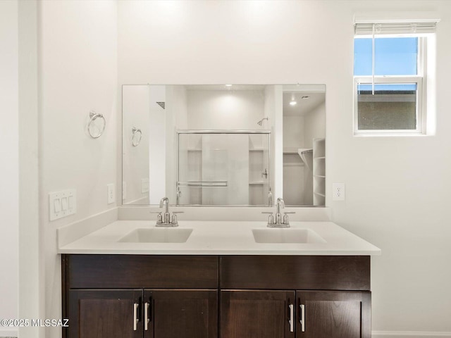 4710 E Julian Wash Dr, Tucson, AZ 85706 - bathroom featuring a shower with shower door and double vanity
