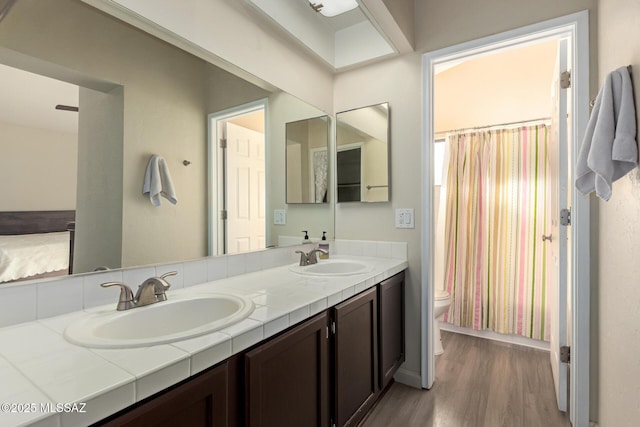 681 W Mountain Ridge Dr, Oro Valley, AZ 85737 - bathroom with toilet, wood finished floors, double vanity, and a shower with shower curtain