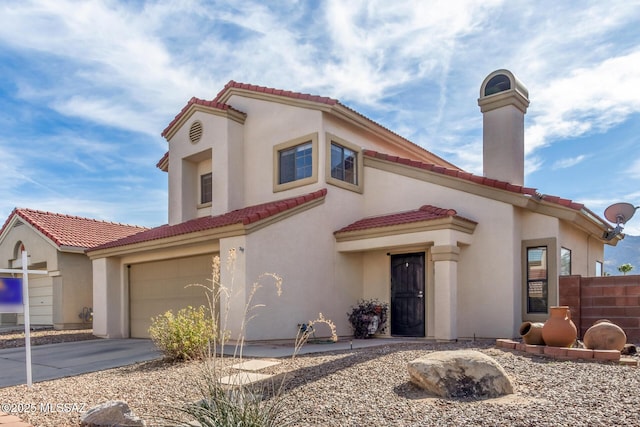 681 W Mountain Ridge Dr, Oro Valley, AZ 85737 - mediterranean / spanish-style house featuring a garage, a tile roof, concrete driveway, a chimney, and stucco siding