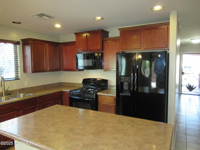 6700 S Stone Fly Dr, Tucson, AZ 85757 - kitchen with black appliances, a sink, healthy amount of natural light, recessed lighting, and light countertops