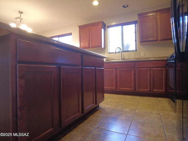 6700 S Stone Fly Dr, Tucson, AZ 85757 - kitchen featuring reddish brown cabinets, a sink, recessed lighting, and light tile patterned floors