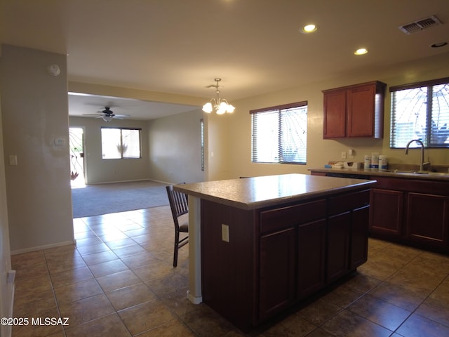 6700 S Stone Fly Dr, Tucson, AZ 85757 - kitchen featuring a sink, a center island, recessed lighting, baseboards, and dark colored carpet