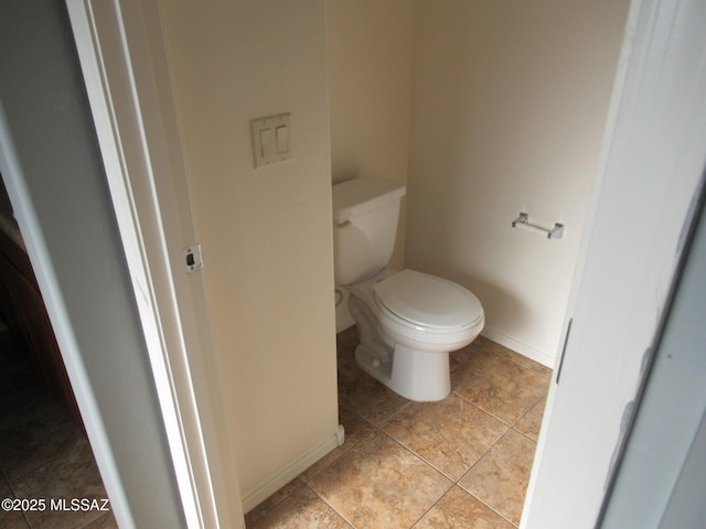 6700 S Stone Fly Dr, Tucson, AZ 85757 - bathroom featuring baseboards, toilet, and tile patterned floors