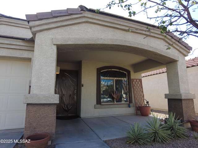 6700 S Stone Fly Dr, Tucson, AZ 85757 - view of exterior entry with stucco siding and covered porch