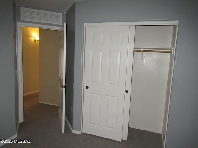 6700 S Stone Fly Dr, Tucson, AZ 85757 - unfurnished bedroom featuring a closet, baseboards, and dark colored carpet