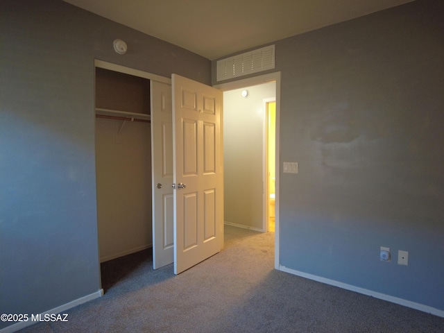 6700 S Stone Fly Dr, Tucson, AZ 85757 - unfurnished bedroom with carpet flooring, a closet, and baseboards