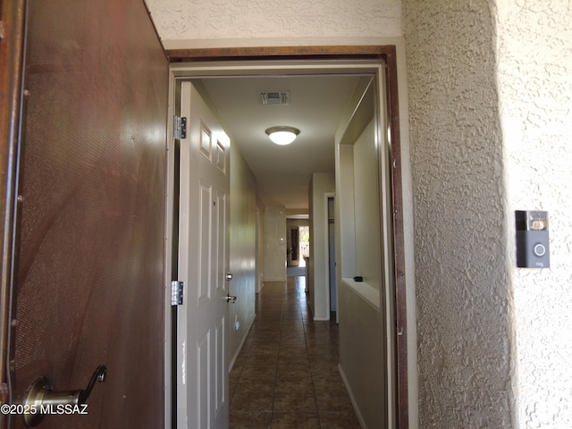 6700 S Stone Fly Dr, Tucson, AZ 85757 - hallway featuring dark tile patterned flooring