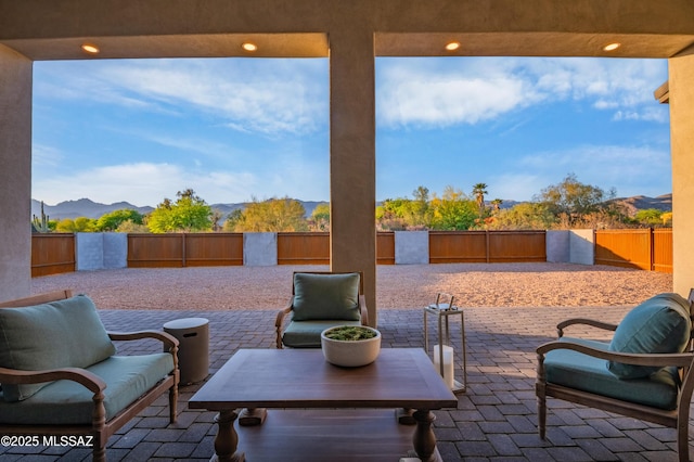 view of patio with a mountain view and a fenced backyard