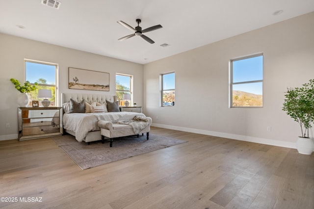 bedroom with wood finished floors, baseboards, and ceiling fan