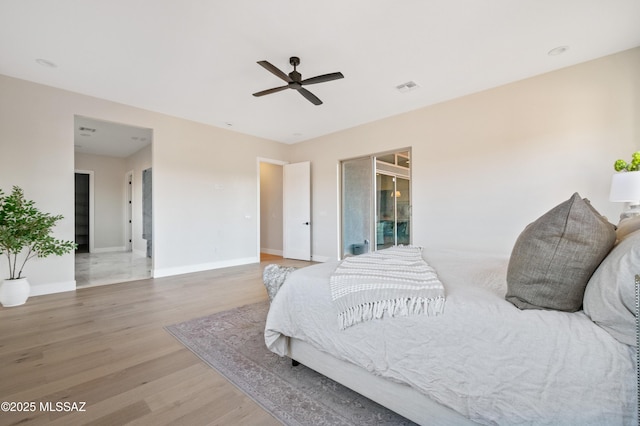 bedroom with wood finished floors, baseboards, and ceiling fan