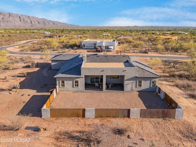 view of subject property with mountains and a desert landscape