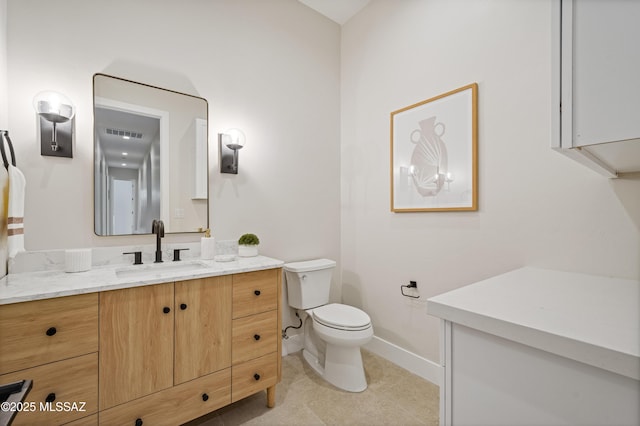 bathroom featuring toilet, baseboards, tile patterned floors, and vanity