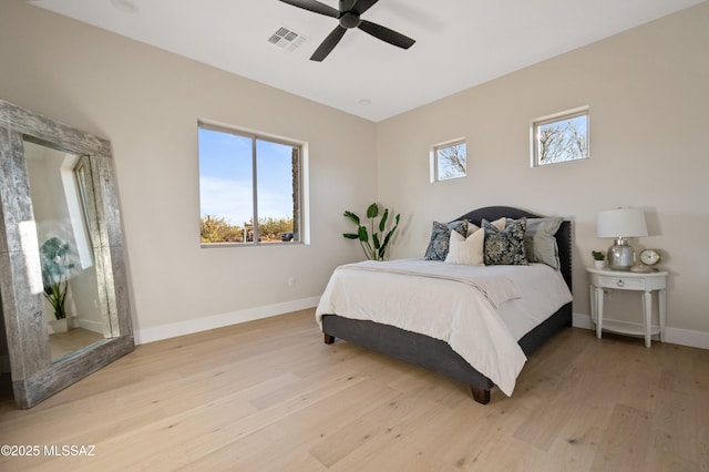 bedroom with baseboards, light wood-style floors, and a ceiling fan